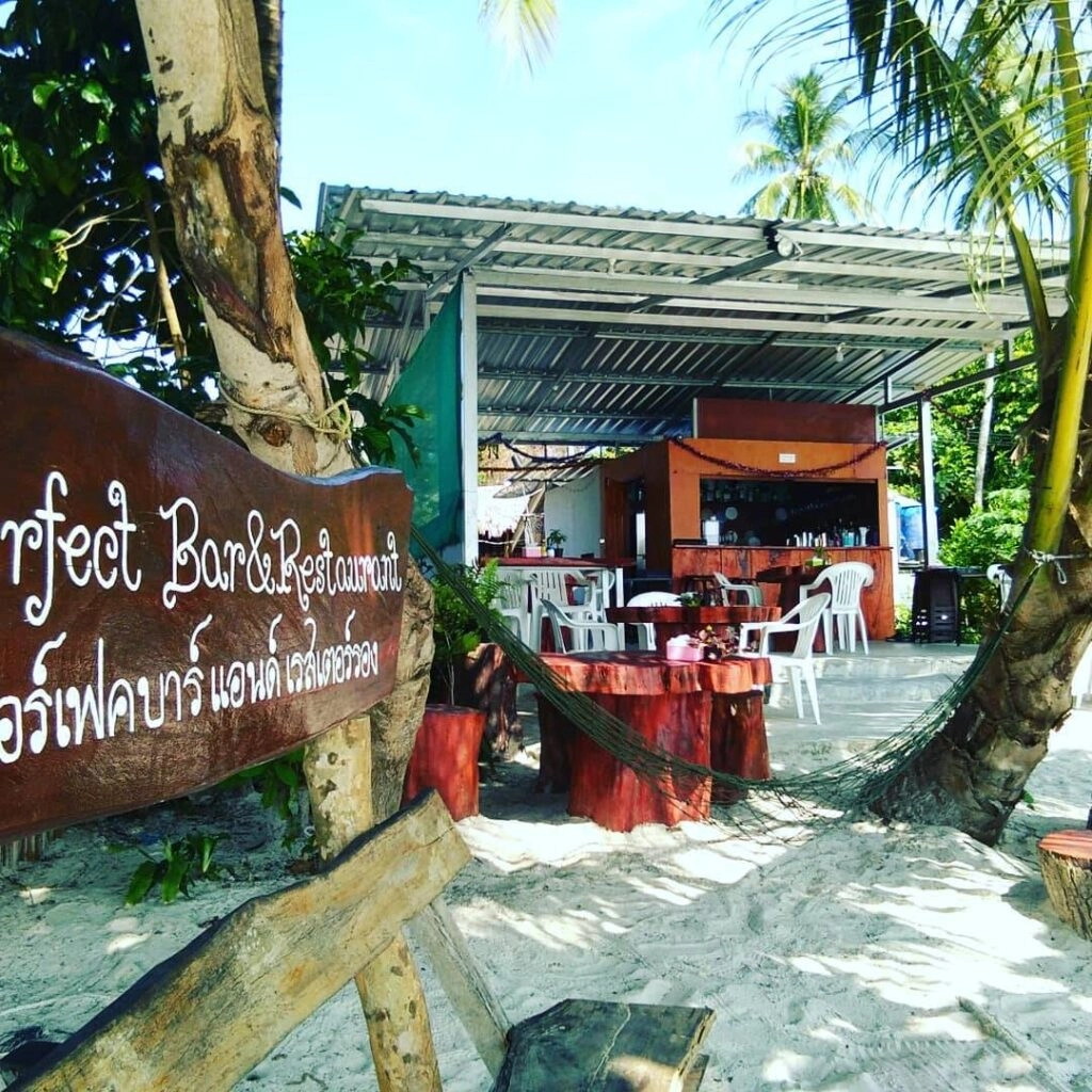 Current image: Perfect Bar & Restaurant on the beach, featuring outdoor seating and tropical surroundings