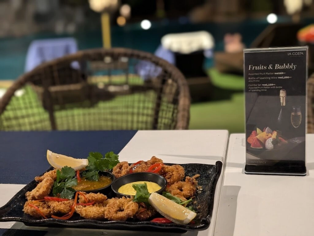 Crispy fried seafood platter with lemon wedges and dipping sauce on a restaurant table
